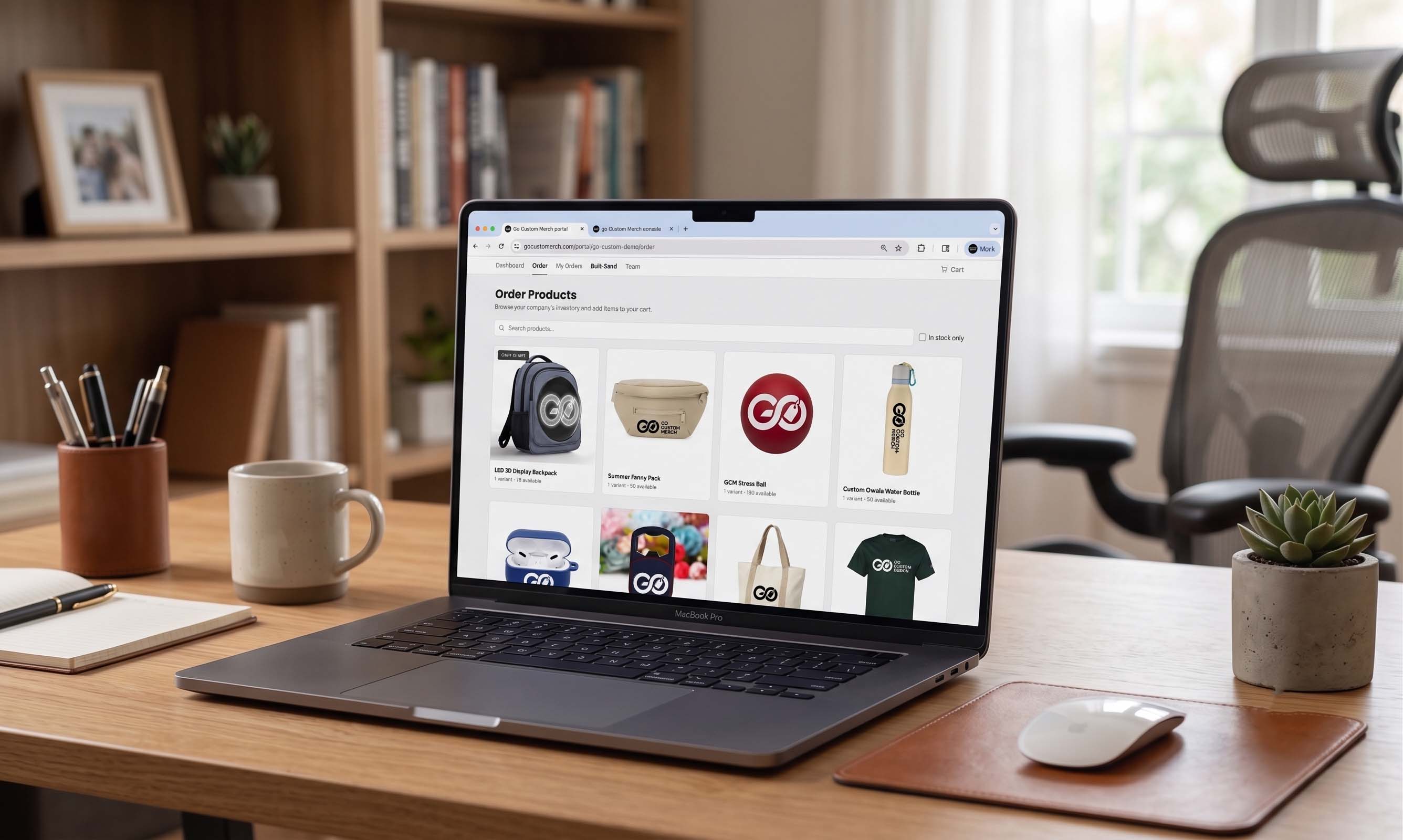 A team member ordering branded merch from the portal on a laptop