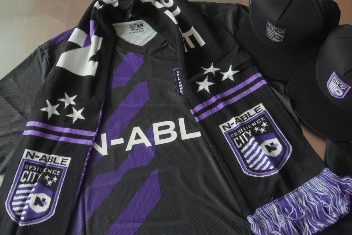 Custom team kit with branded jerseys, knit scarves, and snapback caps